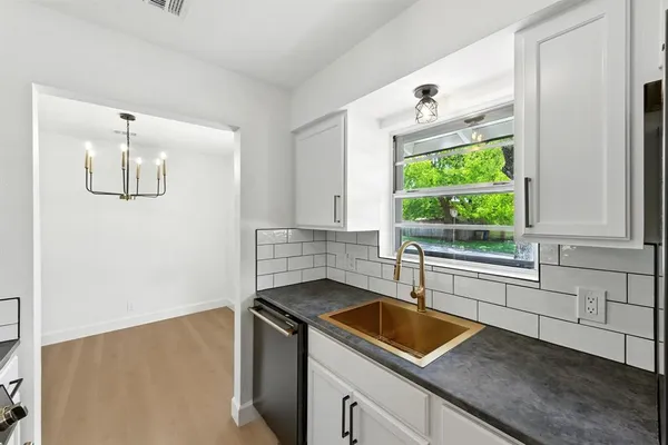 a kitchen with a sink and a window