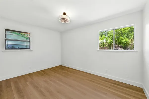 a view of a room with wooden floor and window