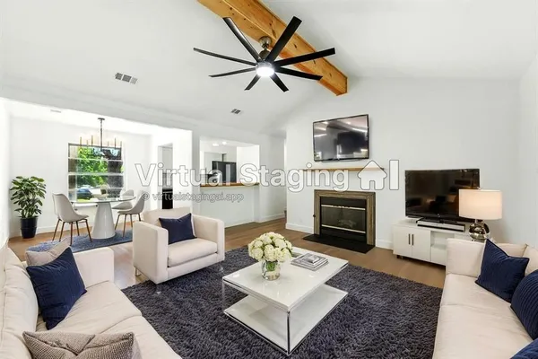 a living room with furniture a fireplace and a flat screen tv