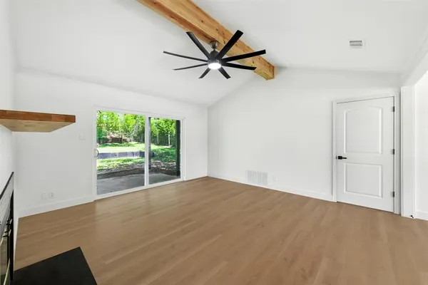 a view of a livingroom with a ceiling fan and window