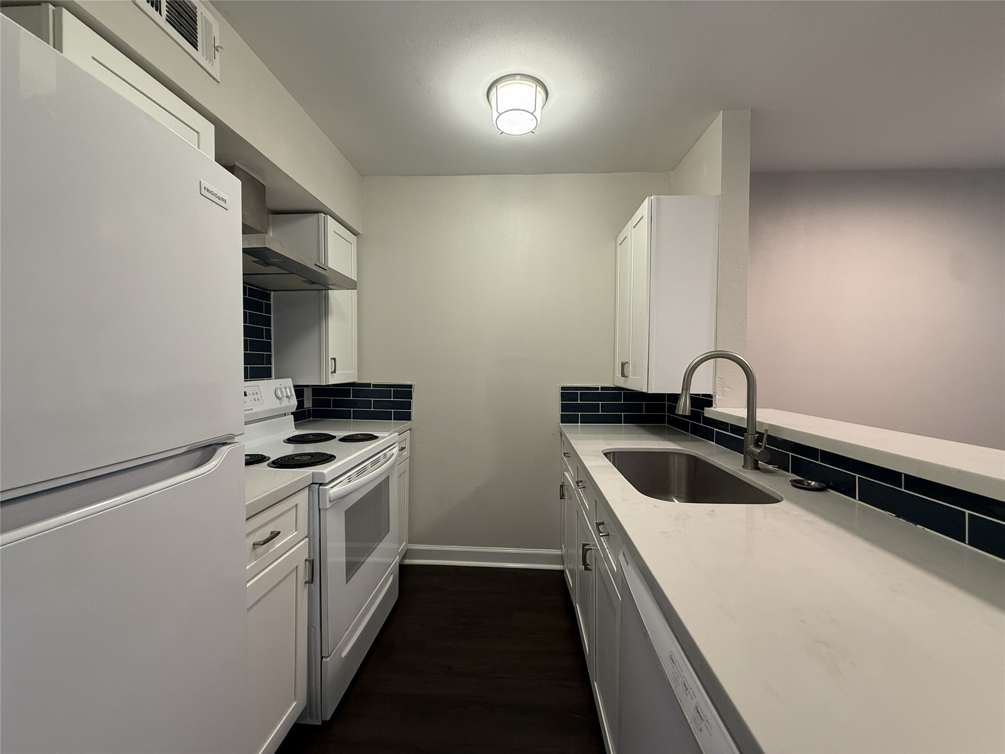 1824 Thonig Road, Unit 10 Houston, TX 77055 - Photo 6 of 17 a kitchen with stainless steel appliances a sink a stove and a refrigerator