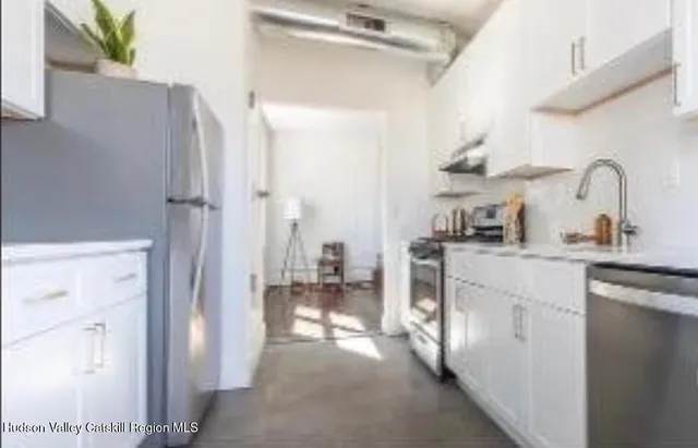 a bathroom with a sink a toilet a mirror and shower