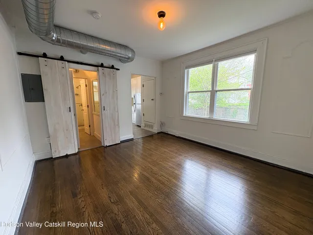 wooden floor in an empty room with a window