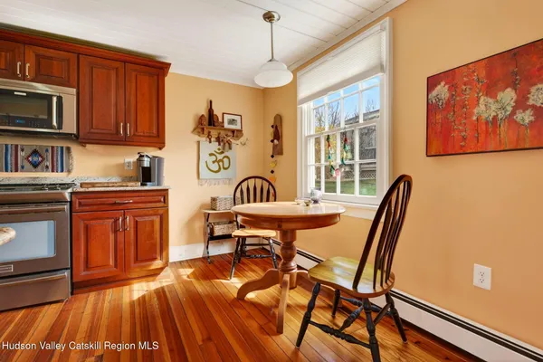 a dining room with furniture and window