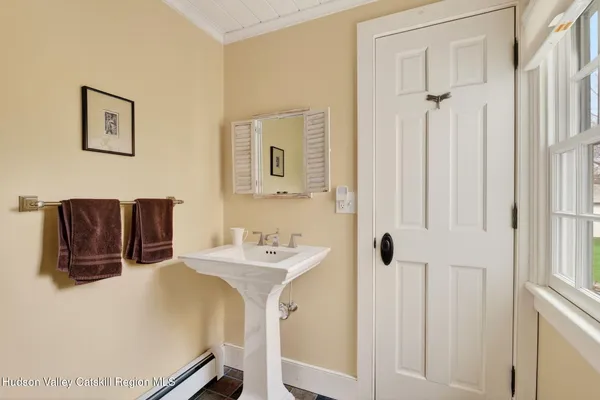 a bathroom with a sink a mirror and shower