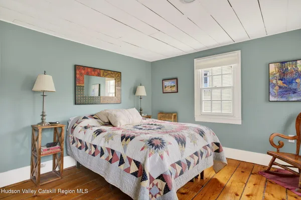a bedroom with bed and a window