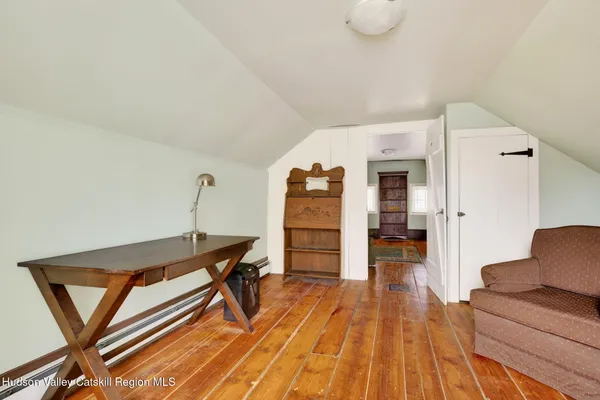 a bedroom with furniture and wooden floor