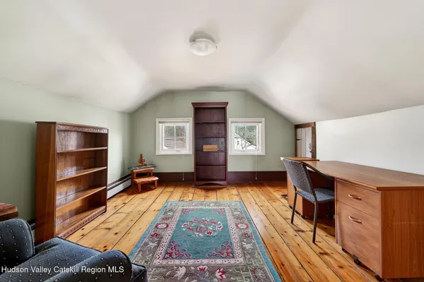 a living room with furniture fireplace and window