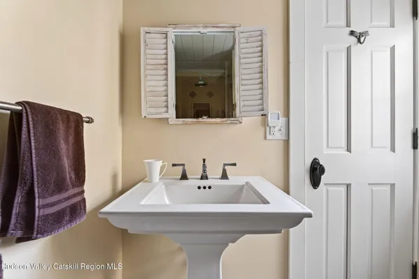 a bathroom with a sink a mirror and shower