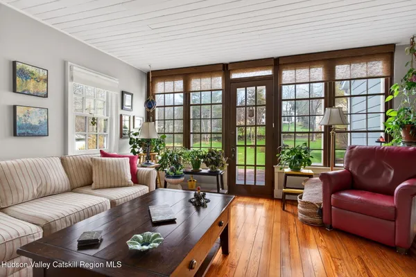 a living room with furniture and floor to ceiling windows