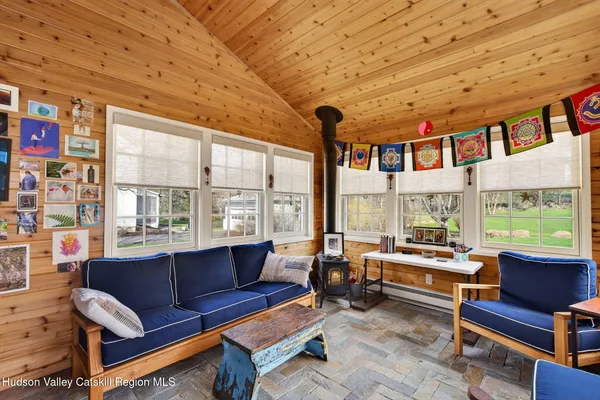 a living room with furniture a rug and a large window