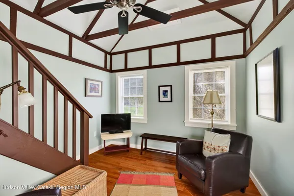 a living room with furniture a flat screen tv and a window