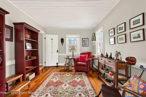 a living room with furniture and a book shelf