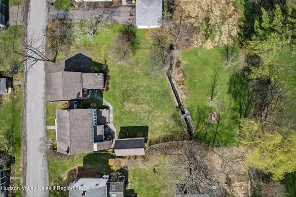 an aerial view of a house with a yard basket ball court and outdoor seating