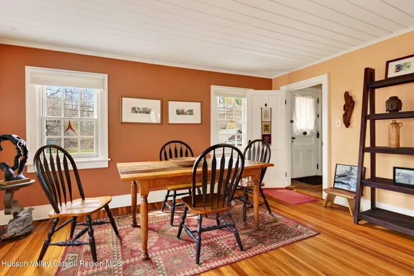 a view of a dining room with furniture and wooden floor