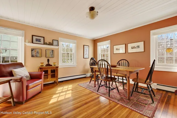a view of a dining room with furniture window and wooden floor