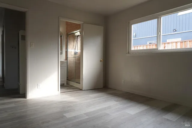 a bathroom with a shower a sink and mirror