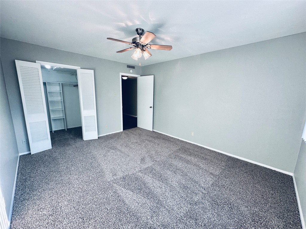 601 West 11th Street, Unit 227 Austin, TX 78701 - Photo 13 of 18 a view of an empty room with a fan