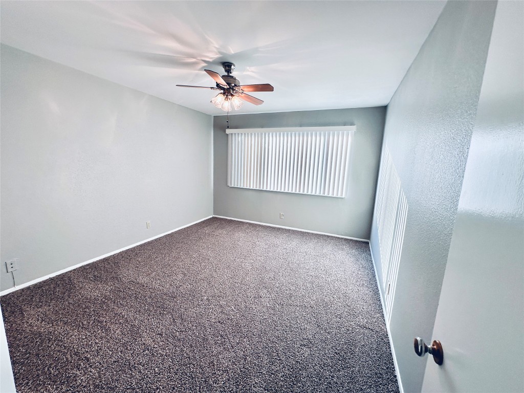 601 West 11th Street, Unit 227 Austin, TX 78701 - Photo 15 of 18 an empty room with windows and fan
