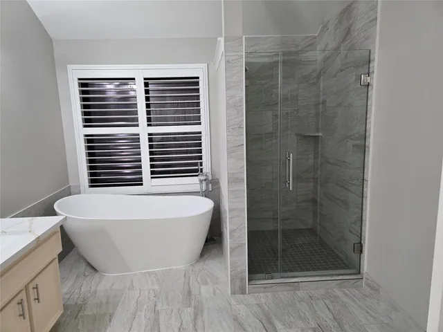 a bathroom with a bathtub and a shower