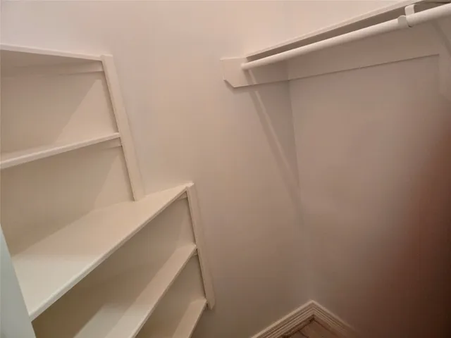 a view of storage and utility room with racks on the wall