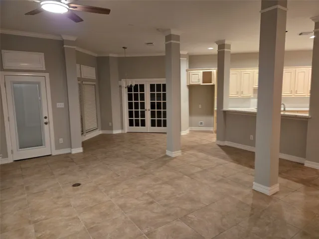 a view of an empty room with a fireplace and a window