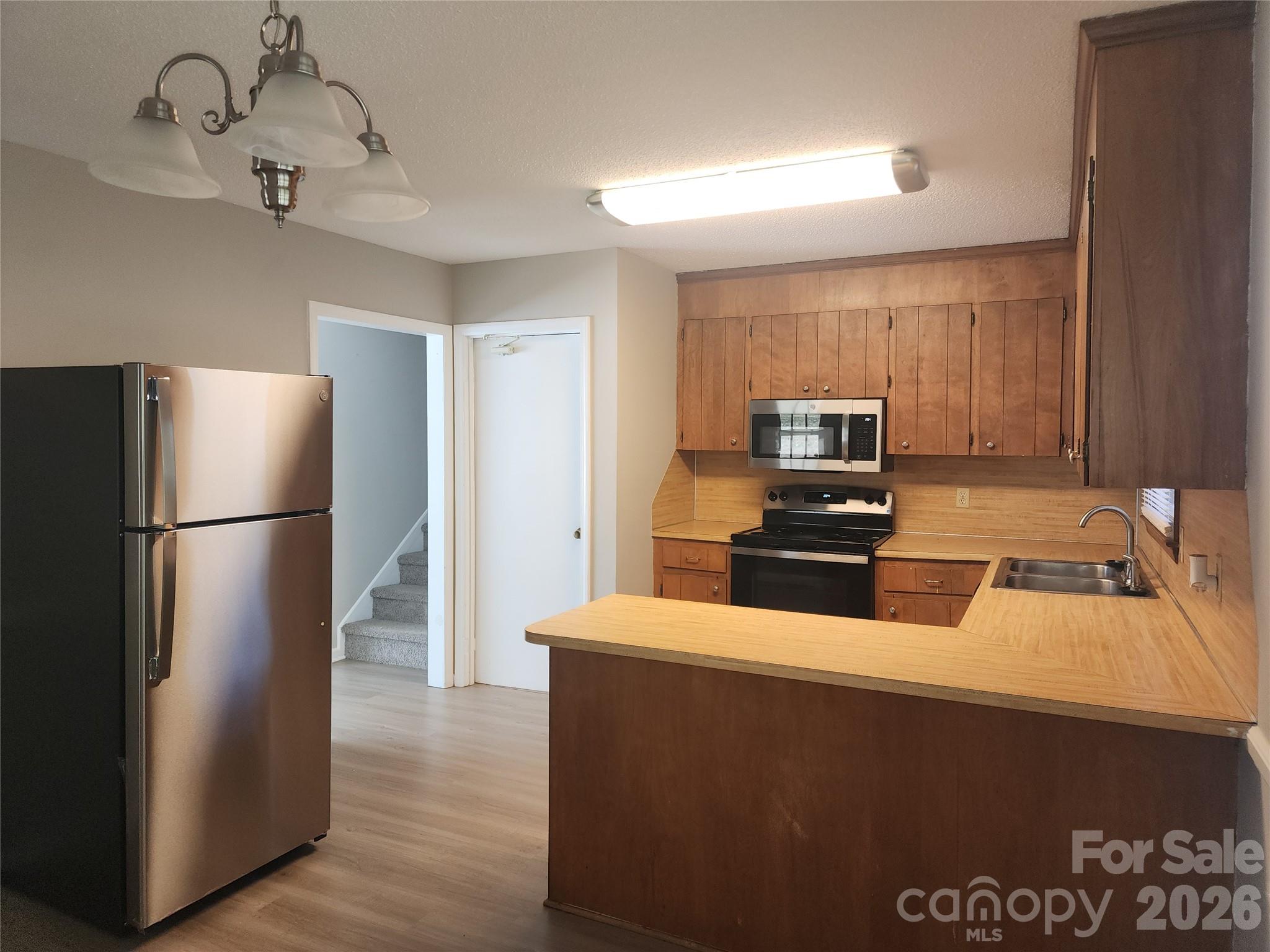 150 Autumn Leaf Road Troutman, NC 28166 - Photo 4 of 21 a kitchen with a refrigerator and a sink