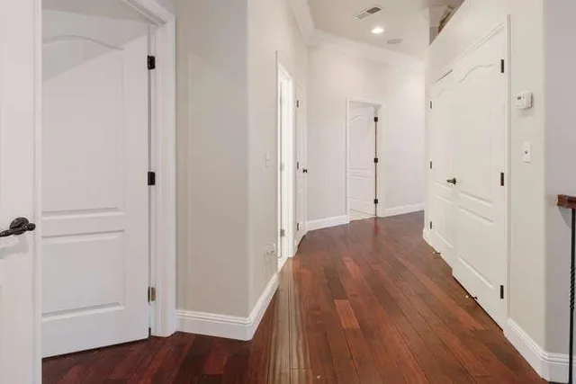 a view of a hallway with wooden floor