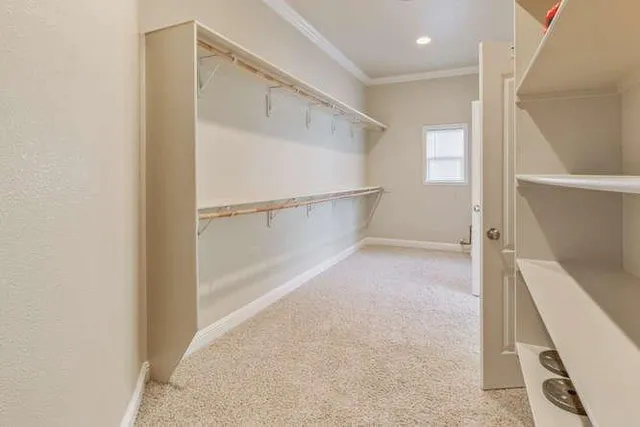 a spacious bathroom with a granite countertop double vanity sink a mirror and a shower
