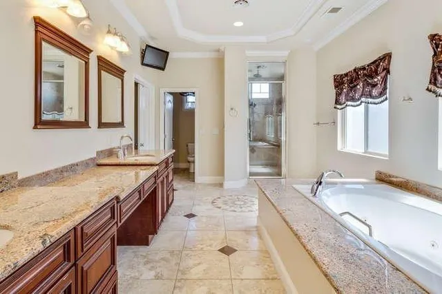 a living room with granite countertop furniture a fireplace and a flat screen tv