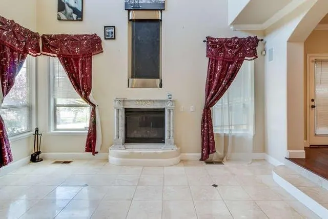 a view of a livingroom with an empty space and a fireplace