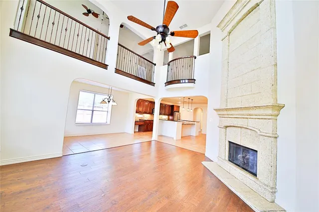 a view of empty room with fireplace and fan