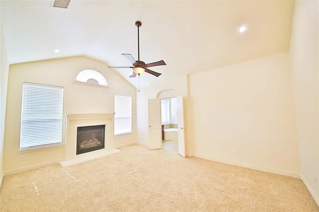 an empty room with closet and windows