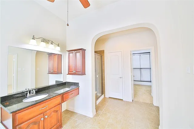 a view of a kitchen with a sink and cabinet with a flat screen tv