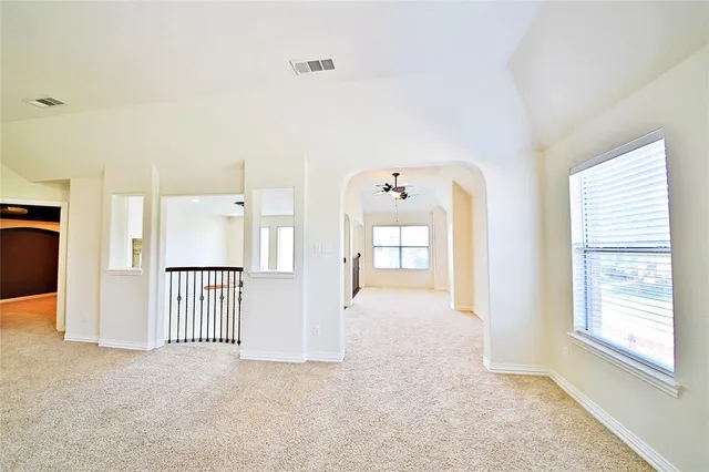 an empty room with windows and closet