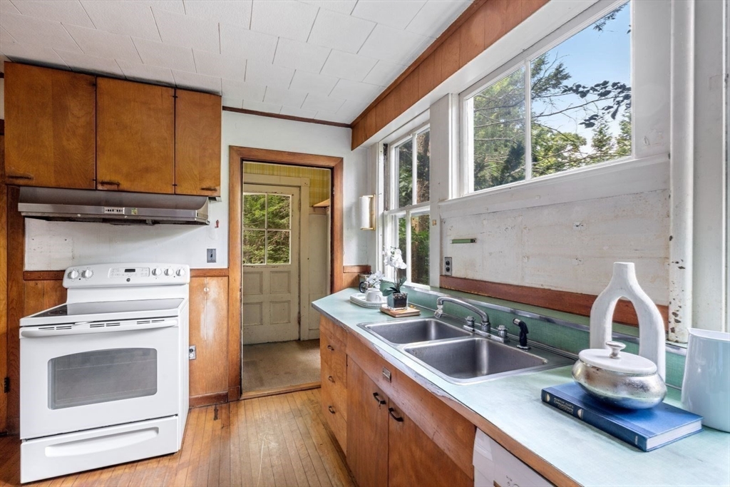 61 Chester Street Newton, MA 02461 - Photo 15 of 42 a kitchen with a stove a sink and a microwave