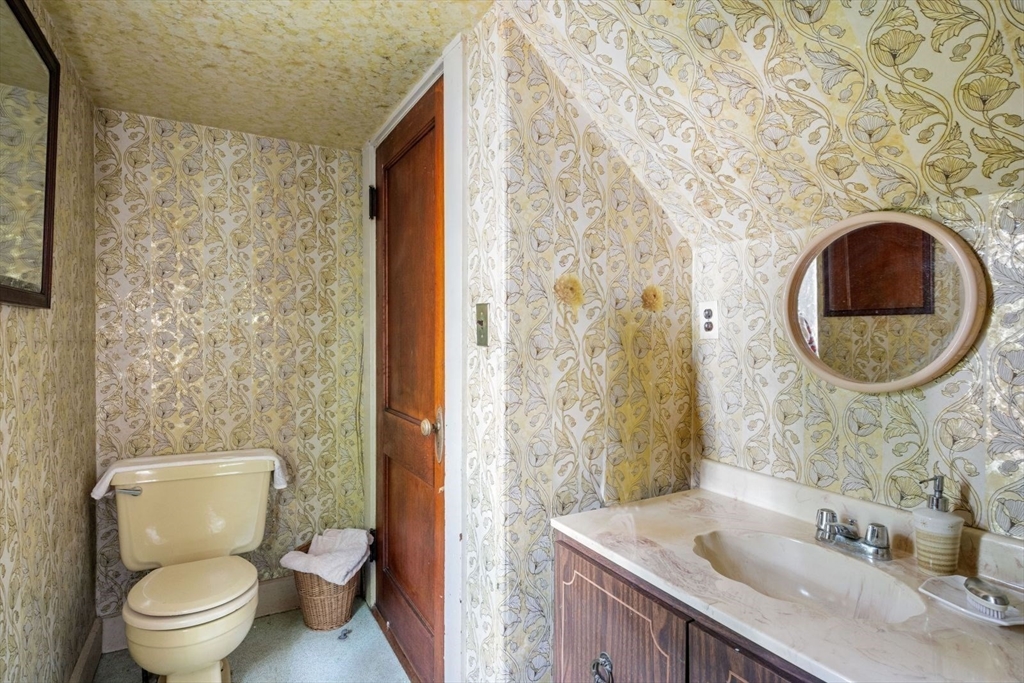 61 Chester Street Newton, MA 02461 - Photo 16 of 42 a bathroom with a granite countertop toilet sink and mirror