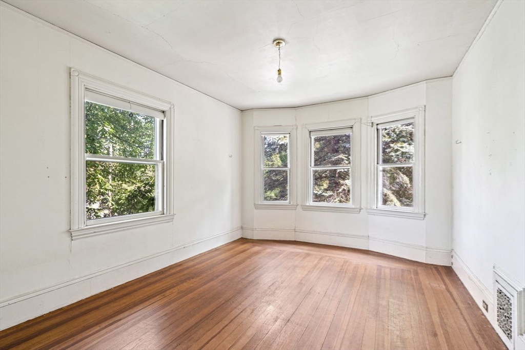 61 Chester Street Newton, MA 02461 - Photo 19 of 42 a view of an empty room with wooden floor and a window