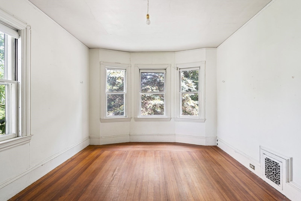 61 Chester Street Newton, MA 02461 - Photo 20 of 42 an empty room with wooden floor and windows