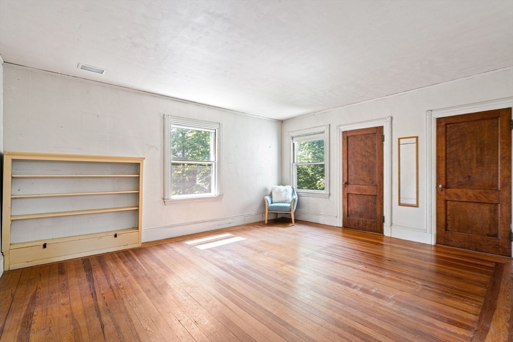 61 Chester Street Newton, MA 02461 - Photo 22 of 42 a view of an empty room with a window and wooden floor