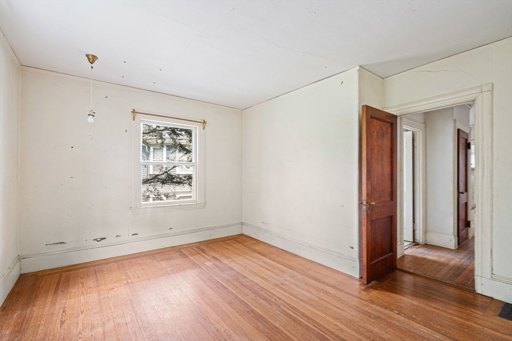 61 Chester Street Newton, MA 02461 - Photo 24 of 42 an empty room with wooden floor and windows
