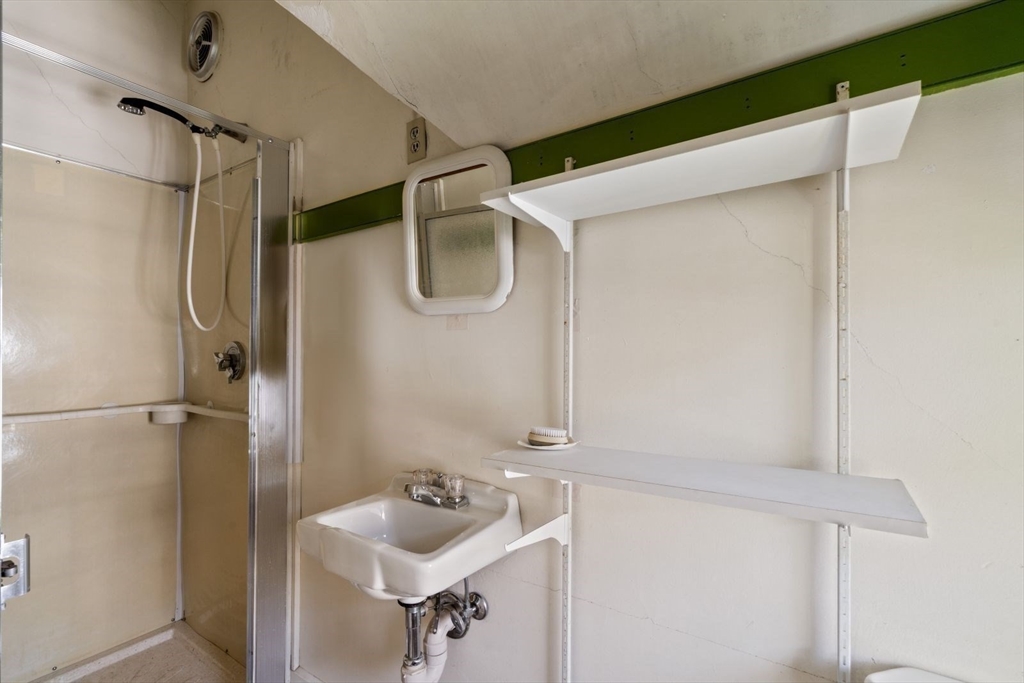61 Chester Street Newton, MA 02461 - Photo 29 of 42 a bathroom with a sink and shower