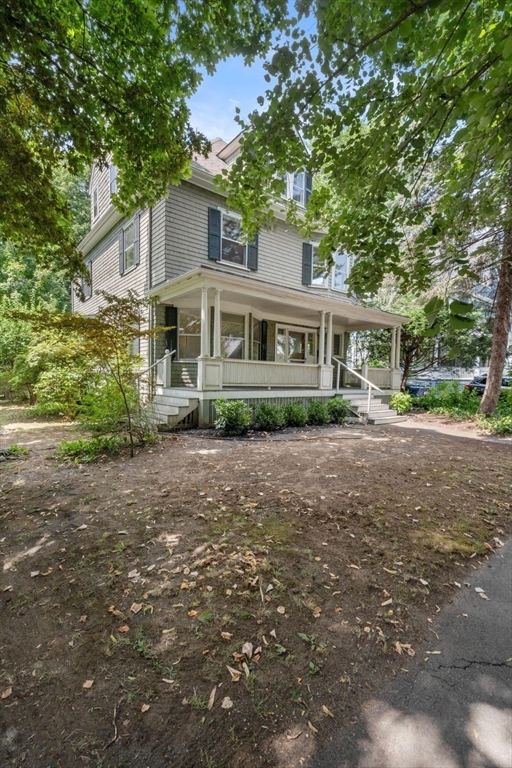61 Chester Street Newton, MA 02461 - Photo 3 of 42 a front view of a house with a yard and trees all around