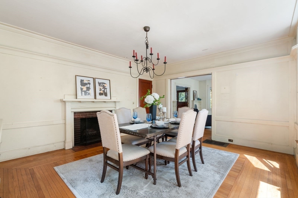 61 Chester Street Newton, MA 02461 - Photo 10 of 42 a dining room with wooden floor a chandelier a wooden table and chairs