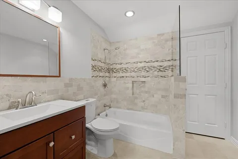 a bathroom with a granite countertop sink and white cabinets