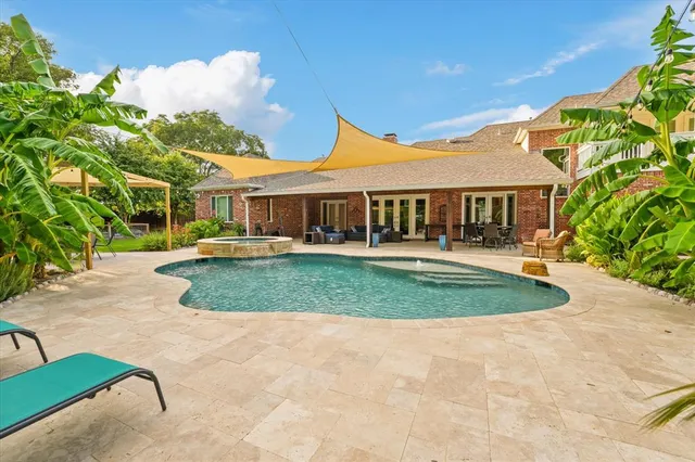 a view of a patio with a table and chairs