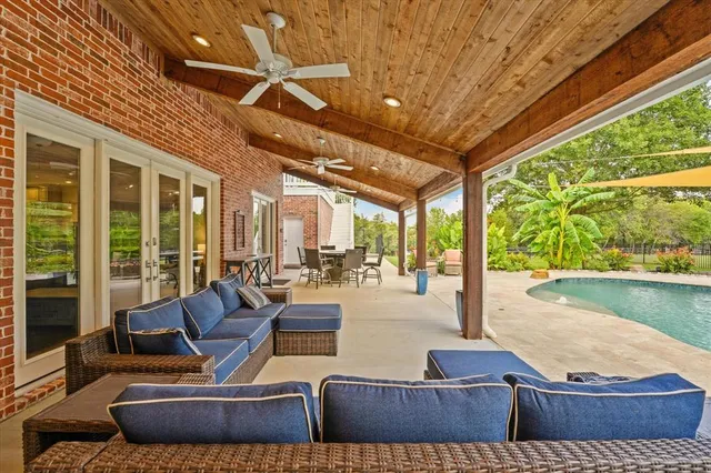 a view of a porch with wooden floor and fence