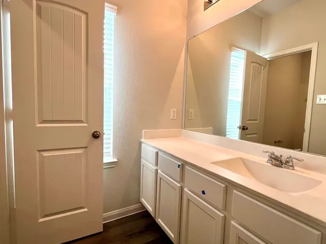 a bathroom with a double vanity sink and a mirror
