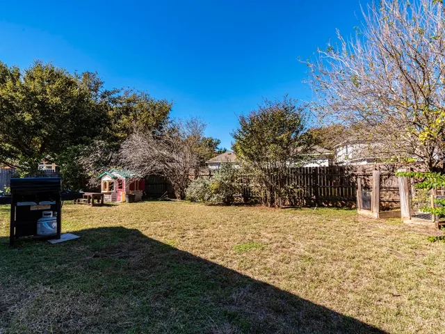 a view of a yard with a house in the background