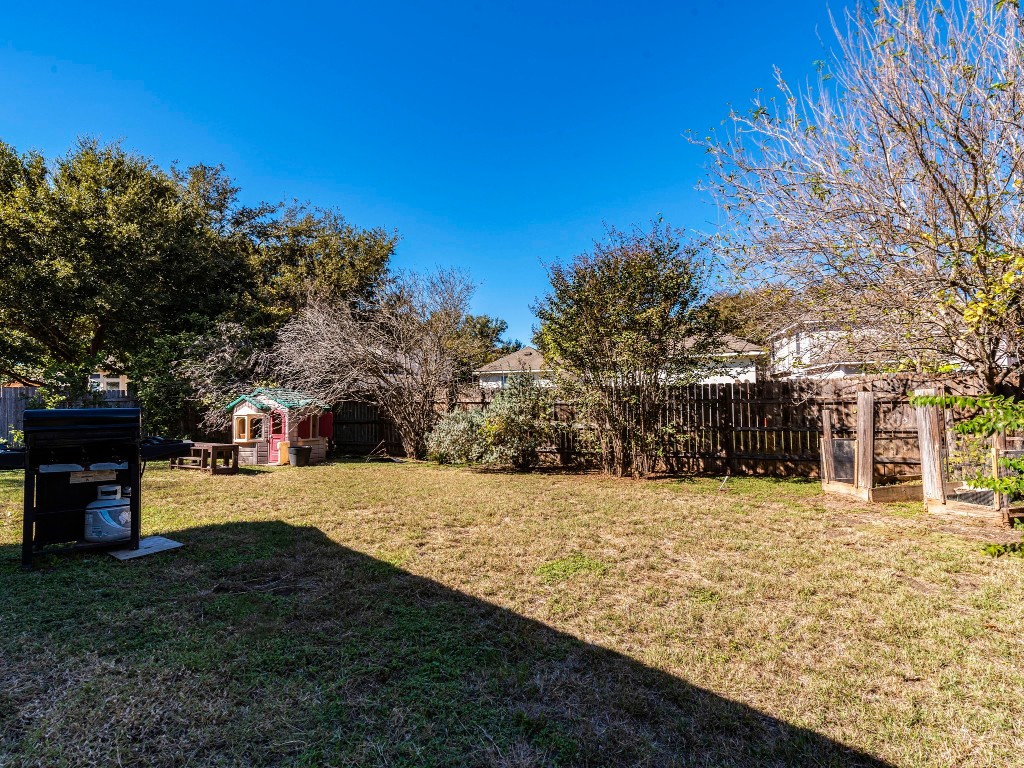 172 Winter Street Kyle, TX 78640 - Photo 13 of 14 a view of a yard with a house in the background